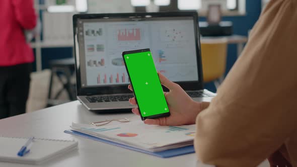 Close Up of Adult Vertically Holding Phone with Green Screen