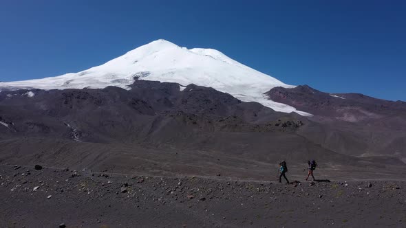 Couple Travelers and Mount Elbrus on Background