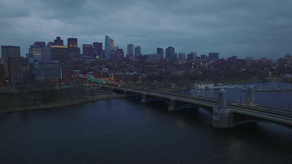 Massive Bridge Over Charles River and Cityscape at Dusk on Cloudy Day