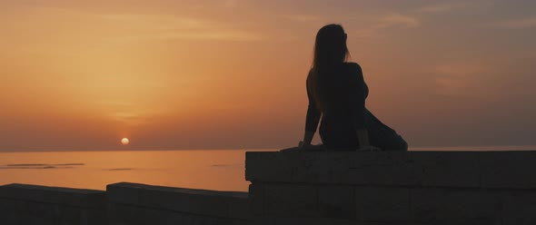 Woman enjoying beautiful sunset