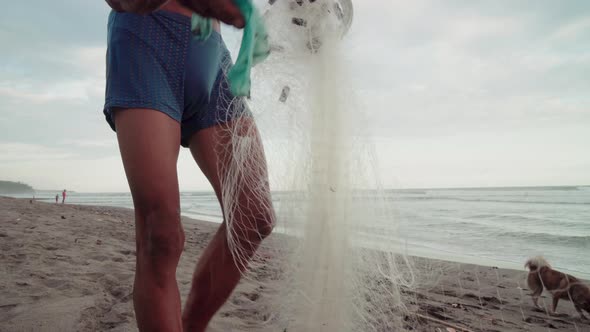 Man Getting Plastic Out Of Fishing Net