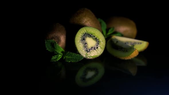 Kiwi Fruit Rotates on a Table on a Black Background