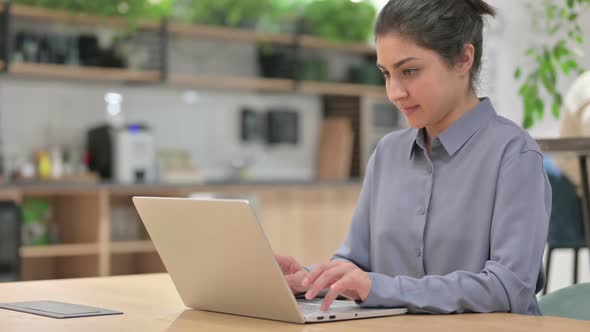 Thumbs Up By Young Indian Woman with Laptop