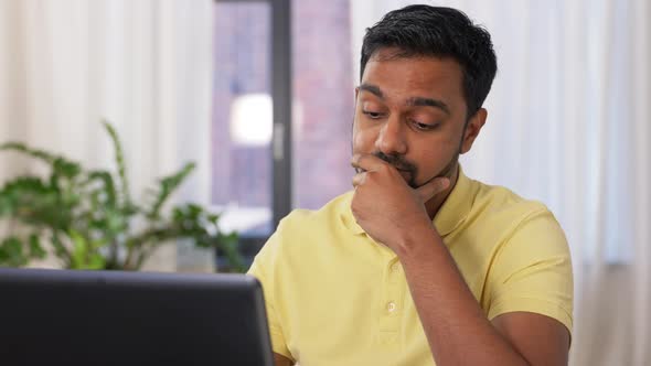 Indian Man with Laptop Working at Home Office