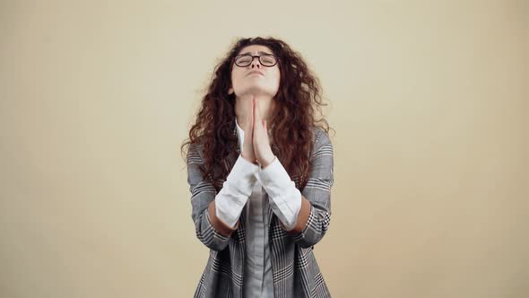 The Desperate Young Woman with Her Hands Clasped Asks for Help and Insists Strongly on Helping Her