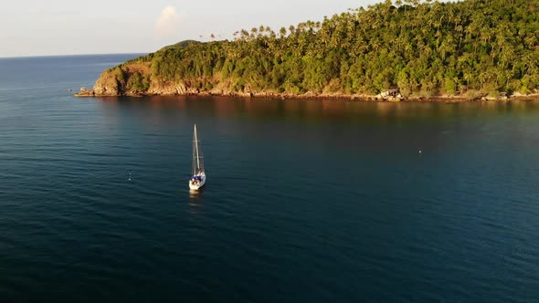 Boat Near Tropical Shore. Amazing Drone View of Modern White Luxury Yacht Sailing on Calm Sea Water