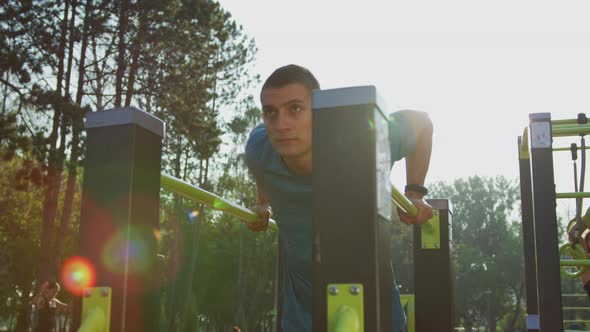 Man exercising on parallel bars