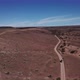 Car Driving on Gravel Road in Aerial Desert - VideoHive Item for Sale