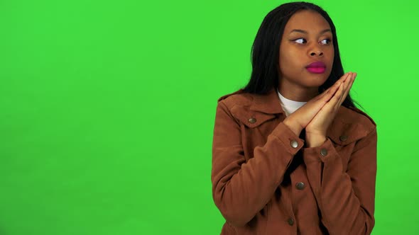 A Black Woman Sleeps with the Head on Her Hands, Then She Wakes Up and Looks Around - Green Screen