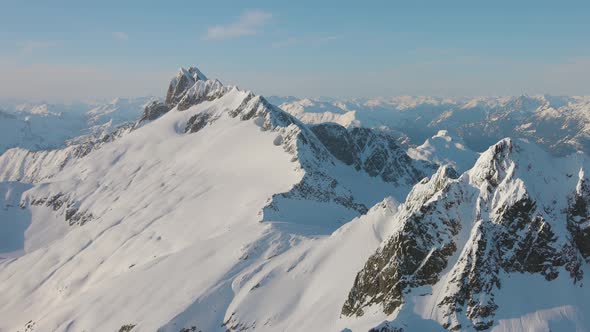 Aerial View From an Airplane of Beautiful Snowy Canadian Mountain Landscape