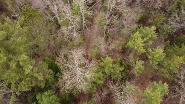 Red Vehicle Drives On The Off-Road Trail In Leota, Michigan With A View Of Tree Tops Of Green Forest