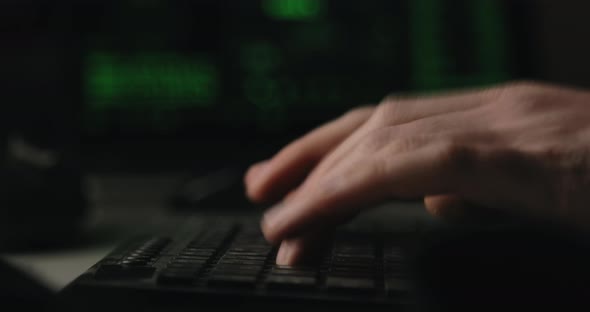 Hacker is Typing Keys on a Keyboard in His Room