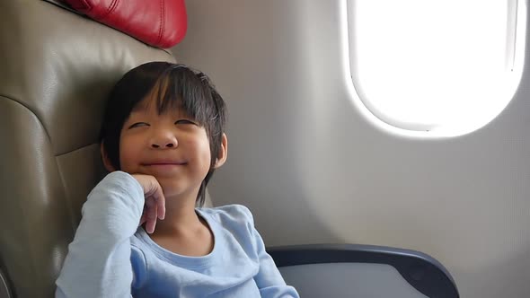 Asian Child Traveling By An Airplane Slow Motion