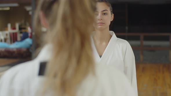 Medium Shot of Female Fighters Bowing Before Karate Training