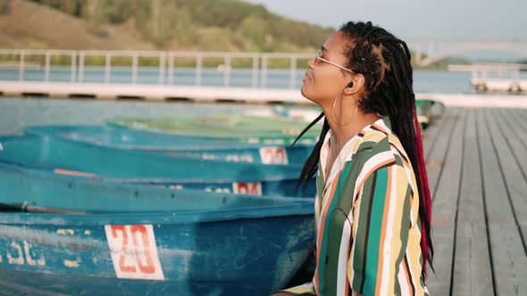 Beautiful African American Woman with Glasses Smiling While Looking at the Camera