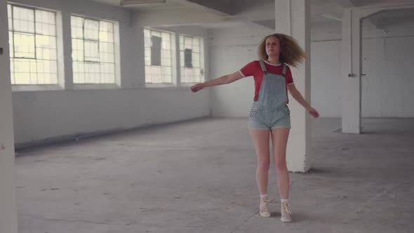 Fashionable young woman in an abandoned warehouse