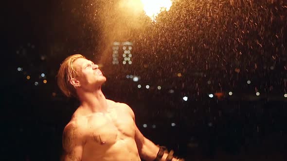 Young Blond Male Breathes Out Large Stream of Fire Making Fireball. Slow Motion Shot.