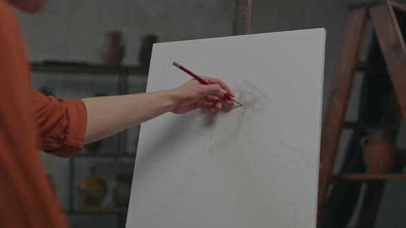Artist Hand Plotting Details of Sketch with Pencil on Canvas