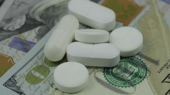 Medical Pills and Tablets on Dollar Banknote. Pharmaceutical Business Concept