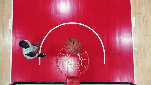 Top View of an Africanamerican Sportsman Scoring in Basketball