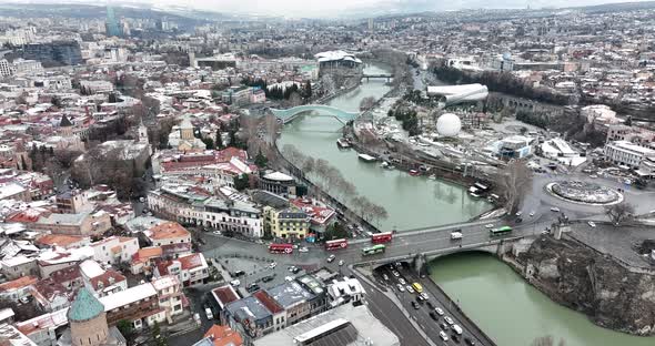 Aerial view of Metekhi church in old Tbilisi located on cliff near river Kura. Georgia 2022 winter