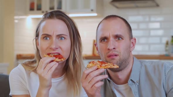 Couple Relaxing, Watching TV and Eating Pizza at Home.