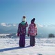 Back View of Children Standing on Rural Roadway in Snow Looking at Mountain Range in Sunshine - VideoHive Item for Sale