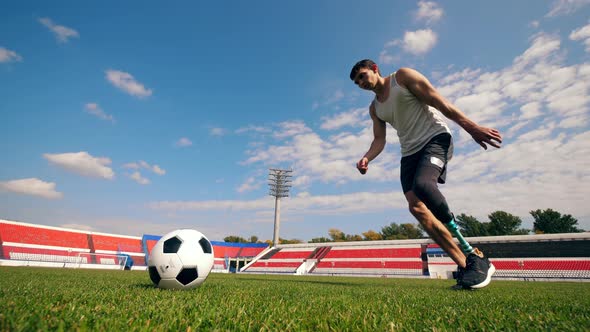 Handicapped Athlete Is Hitting a Football