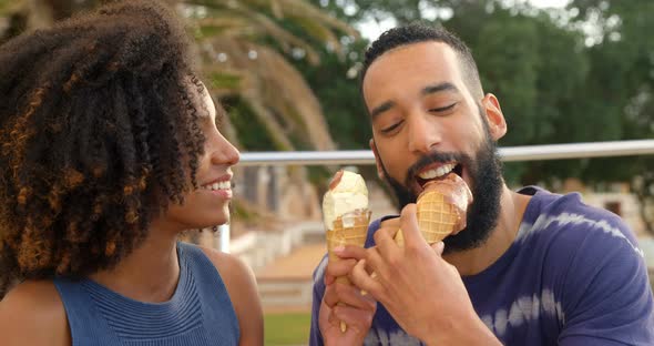 Couple eating ice cream cone at beach 4k