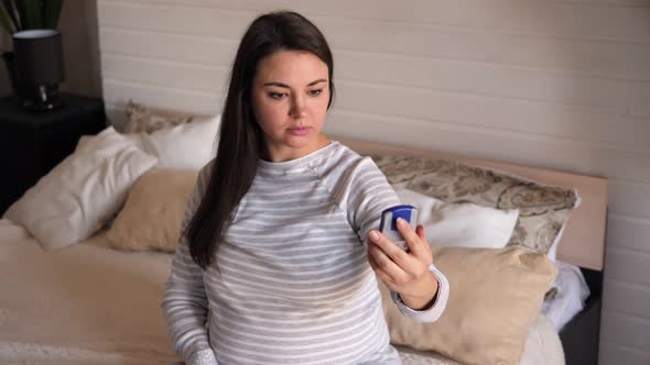 Pregnant Girl Showing Glucose Meter with High Results of Measurement Sugar Level