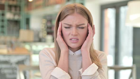 Portrait of Stressed Young Woman Having Headache