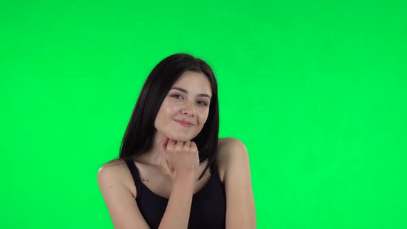 Young Girl Daydreaming and Smiling Looking Up . Green Screen