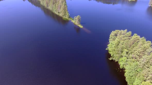 Narrow cape in a Finnish forest lake. Calm lake and beautiful scenery.