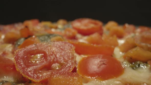 Close up macro view of an artisan pizza coming fresh out of the oven