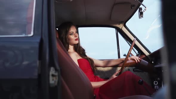 Divine Woman Sits in Front Seat of Car