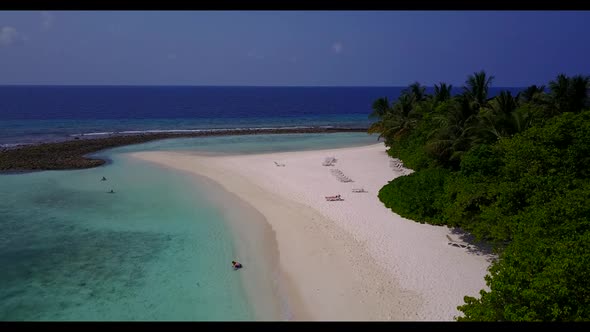 Aerial flying over panorama of relaxing sea view beach time by blue water with bright sand backgroun