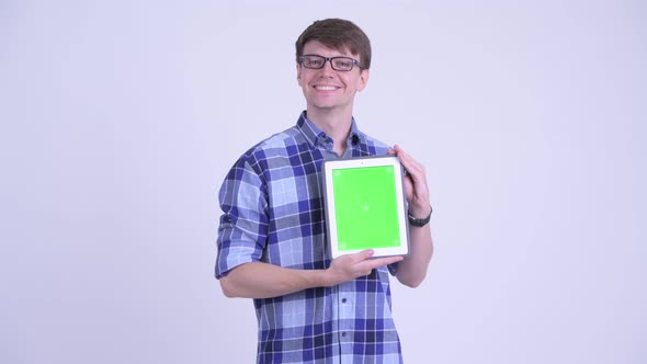 Happy Young Handsome Hipster Man Thinking While Showing Digital Tablet