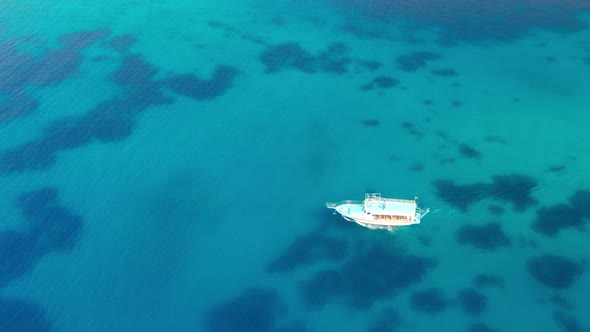 Aerial View of a Boat in the Blue Sea