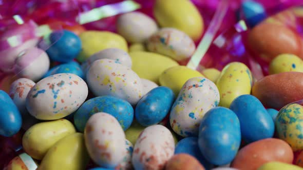 Rotating shot of colorful Easter candies on a bed of easter grass - EASTER 