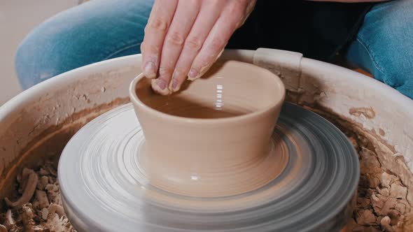 Man Potter Sculpting a Pot - Forming Sides Wider Closer To the Top