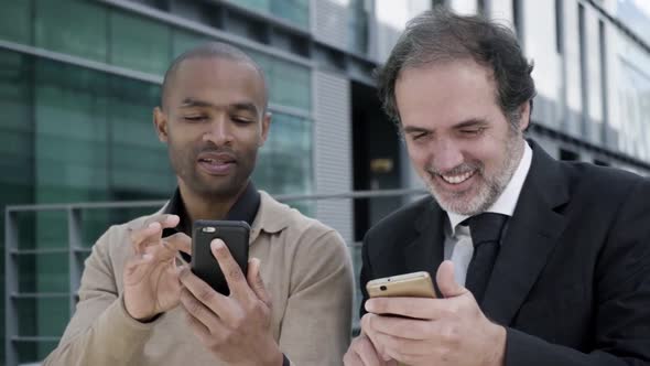 Cheerful Business Colleagues with Cellphones