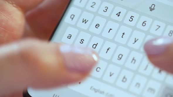 Hands Typing Text on Smartphone Close-up