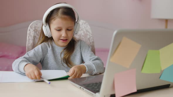 Schoolgirl Girl Studies Online On Laptop At Home