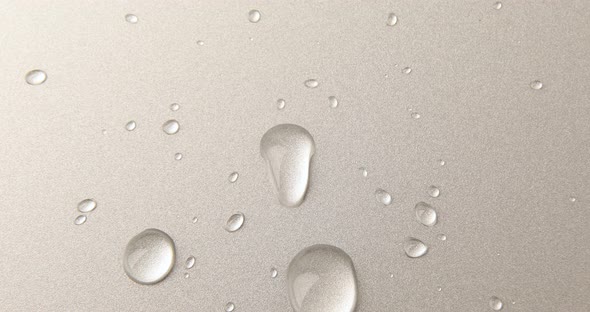 Abstract water drops on grey silver background, macro