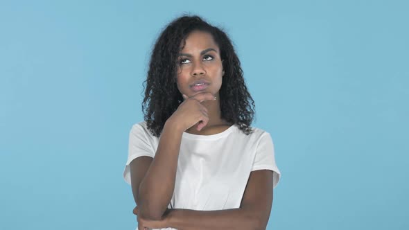 Thinking African Girl Got New Idea Isolated on Blue Background