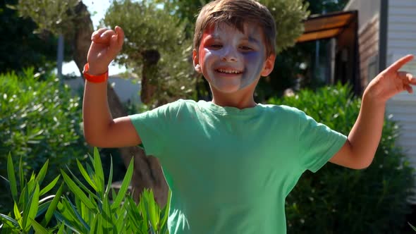 Boy Jumping with Make-up in Form of a French Flag