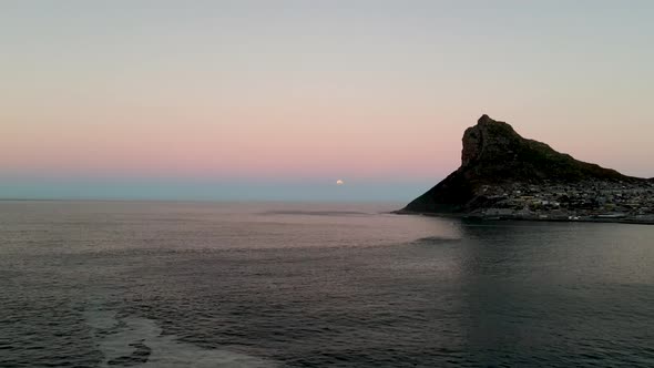 Aerial view of Blood Moon lunar eclipse and dolphins swimming Hout Bay.