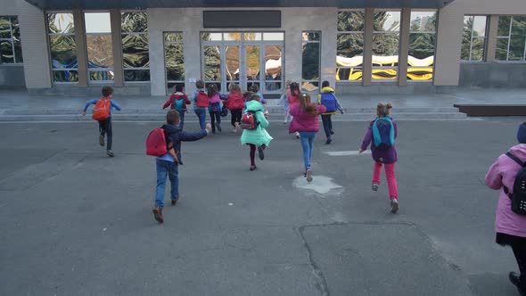 Joyful Elementary Age Kids Running To School Doors