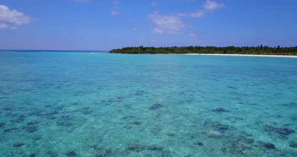 Tropical above clean view of a sandy white paradise beach and aqua turquoise water background in col