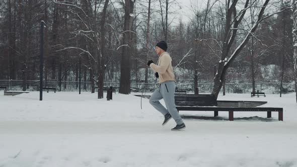 Fit Man Jogger Exercising in Winter Park